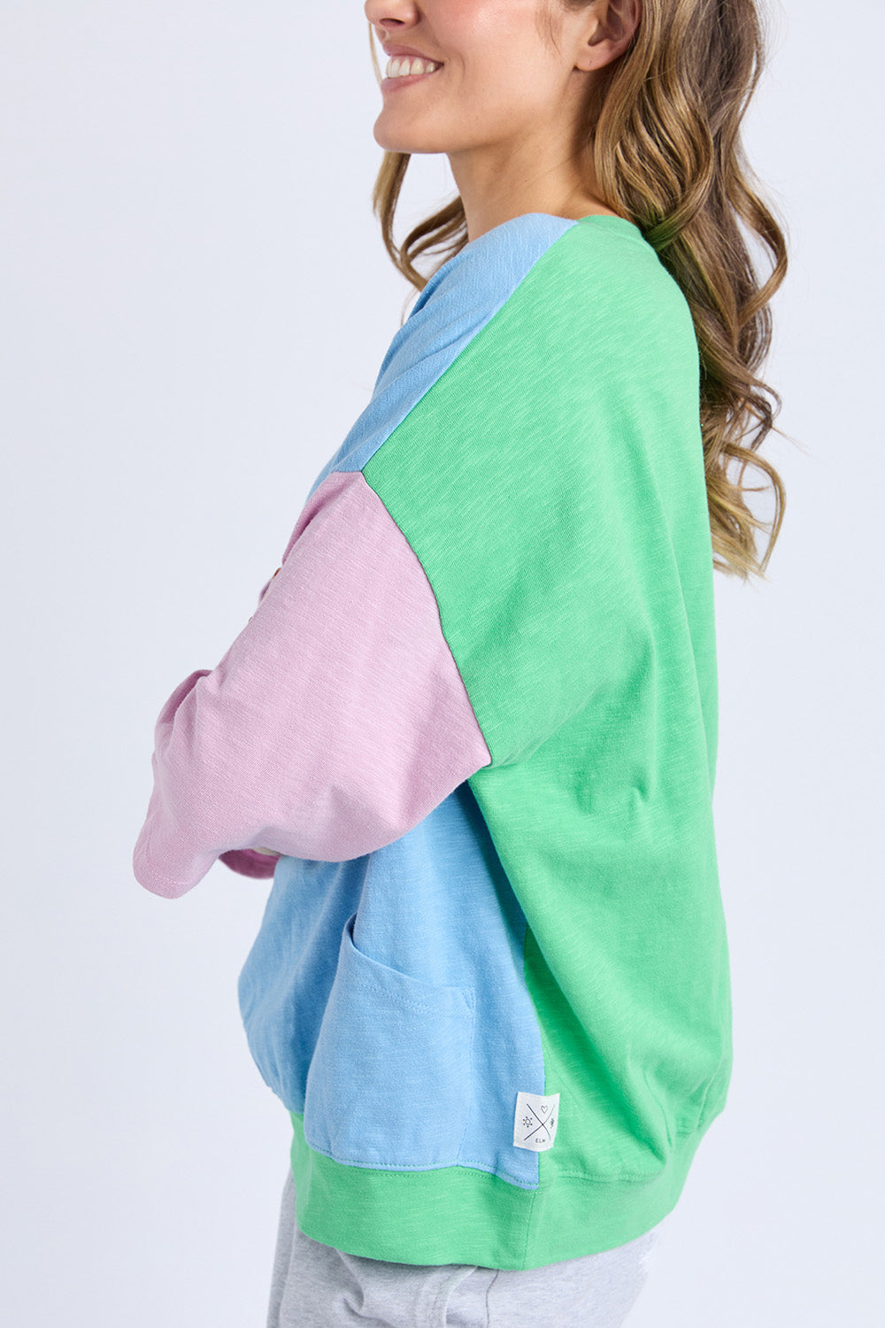 A model wearing the Fundamental Mazie Colour Block Cotton Sweat in colour Blupnkgree (Blue), from the front, cropped image