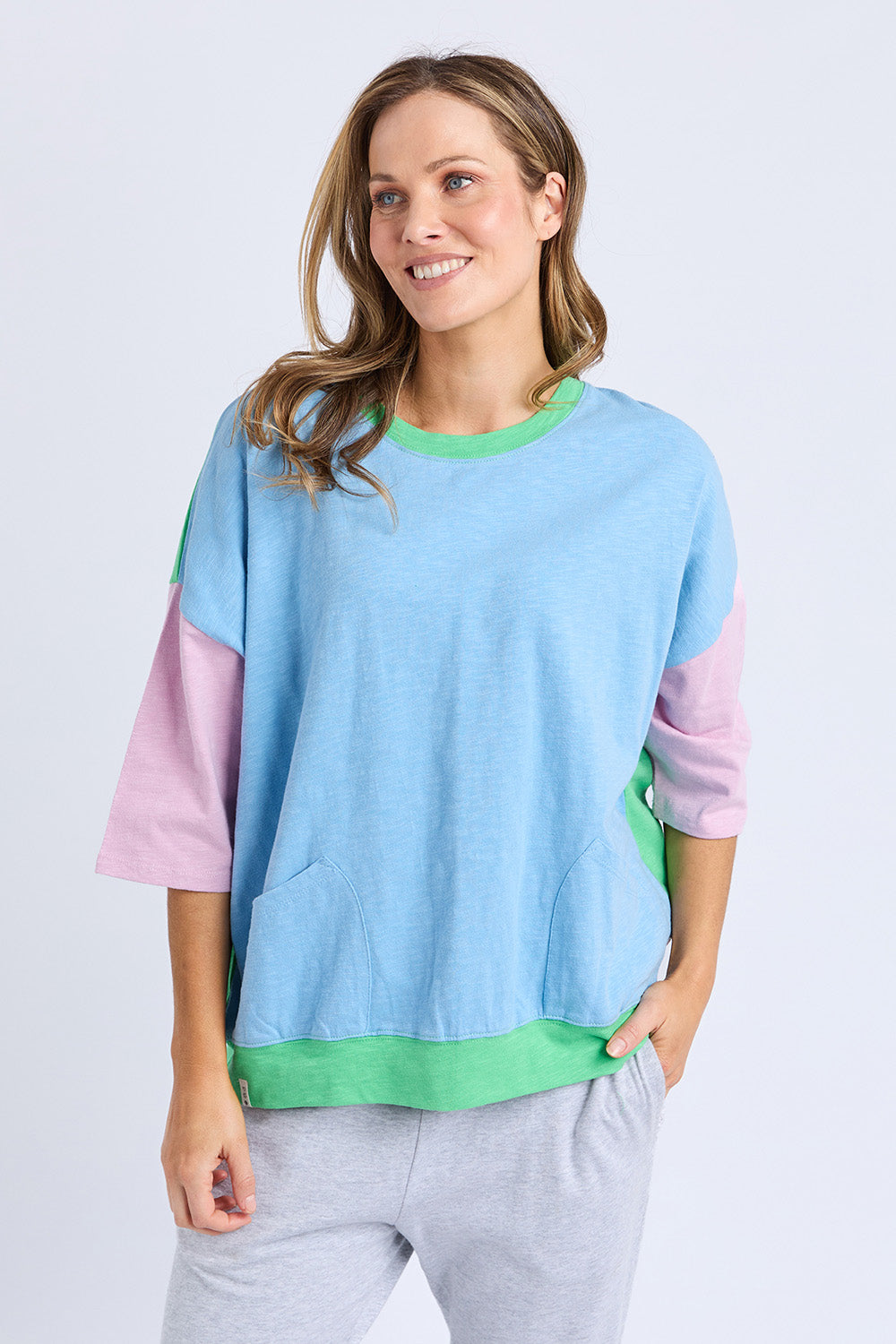 A model wearing the Fundamental Mazie Colour Block Cotton Sweat in colour Blupnkgree (Blue), from the front, cropped image