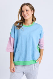 A model wearing the Fundamental Mazie Colour Block Cotton Sweat in colour Blupnkgree (Blue), from the front, cropped image