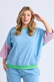 A model wearing the Fundamental Mazie Colour Block Cotton Sweat in colour Blupnkgree (Blue), from the front, cropped image