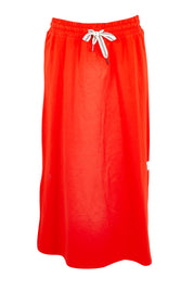 Product shot of the Fundamental Travel Skirt – Tangello in colour Tangello, from the front
