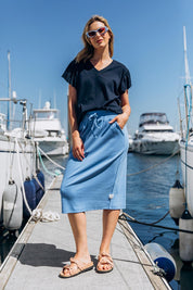 A model wearing the Fundamental Rib Midi Skirt in colour Cerulblue (Blue), from the front, showing the whole outfit