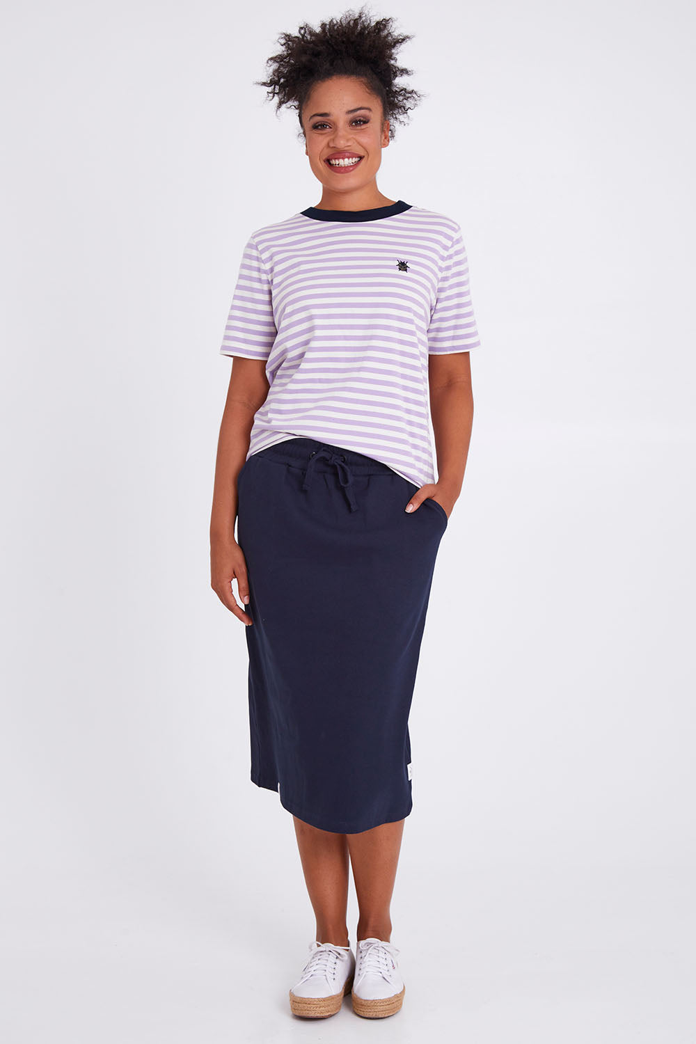 Model Olivia wearing size 10 of the Fundamental Rib Midi Skirt in colour Navy (Blue), from the front, showing the whole outfit