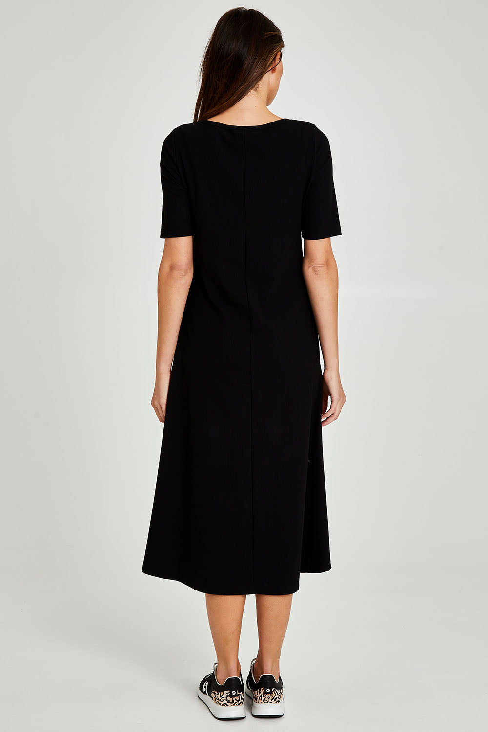 Model Madeline wearing size 10 of the Fundamental Marguerite Dress in colour Black (Black), from the back