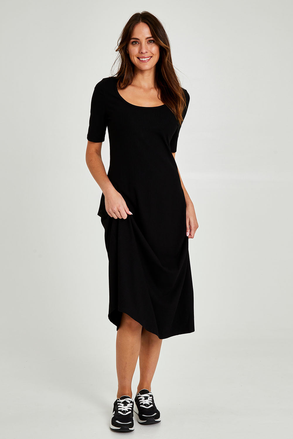Model Madeline wearing size 10 of the Fundamental Marguerite Dress in colour Black (Black), from the front, showing the whole outfit