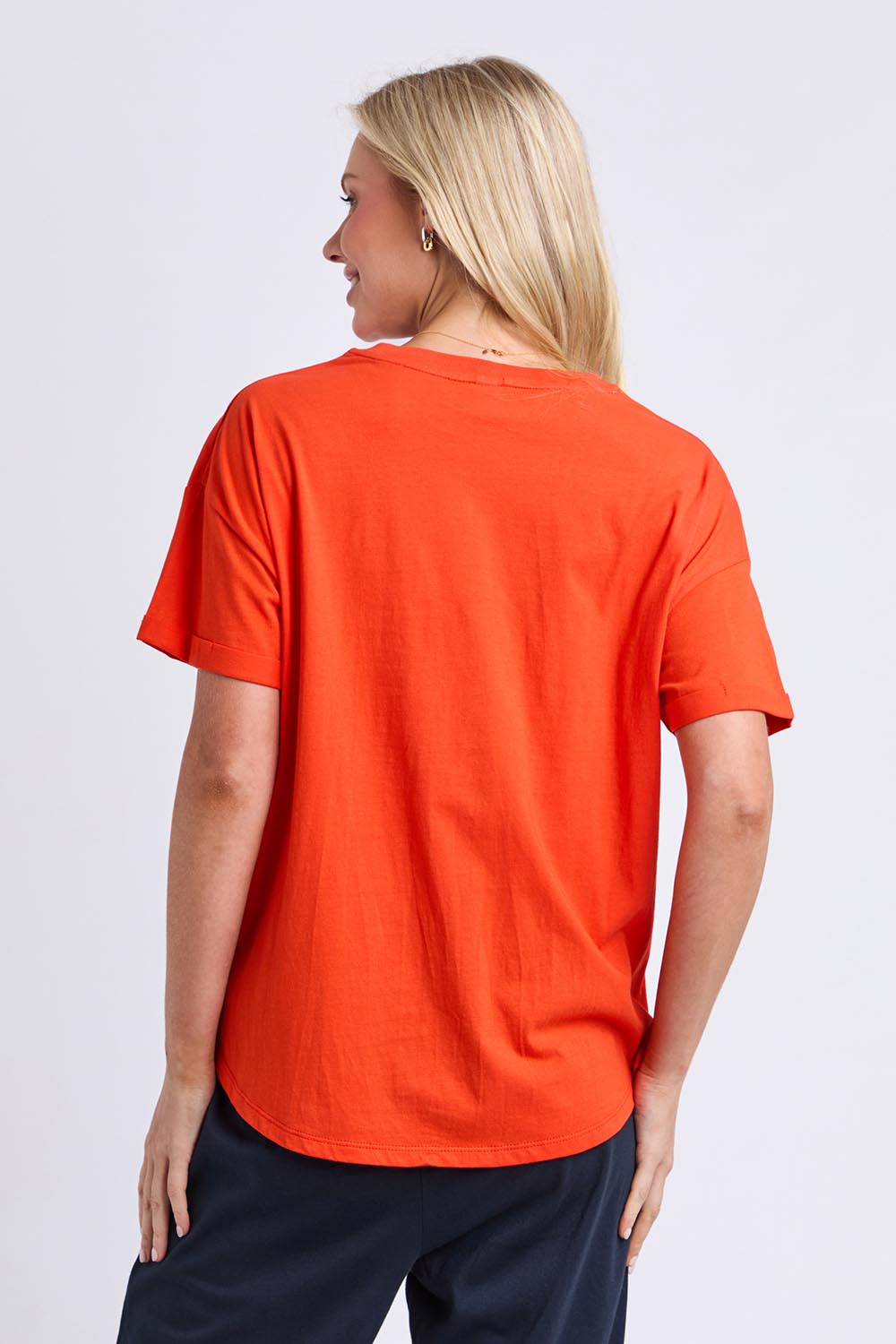 Model Genericm wearing size sample of the Fundamental Halli Cotton Tee – Tangello in colour Tangello, from the back