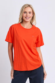 Model Genericm wearing size sample of the Fundamental Halli Cotton Tee – Tangello in colour Tangello, in a cropped view