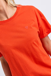Model Genericm wearing size sample of the Fundamental Halli Cotton Tee – Tangello in colour Tangello, in a cropped view