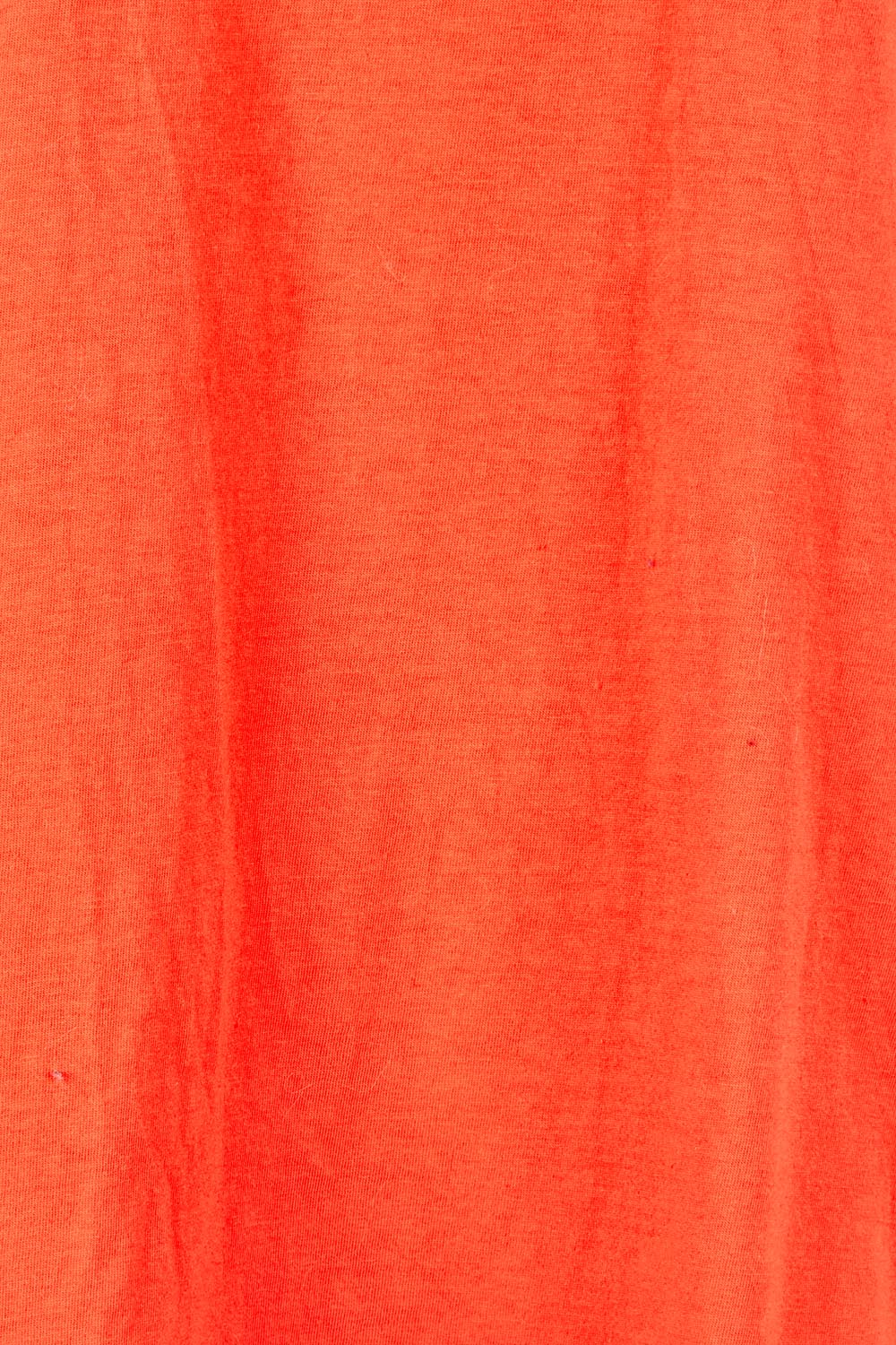 Product shot of the Fundamental Halli Cotton Tee – Tangello in colour Tangello, showing detail