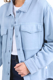 A model wearing the Fundamental Poppy Cotton Fleece Shacket in colour Steelblue (Blue), from the front, cropped image
