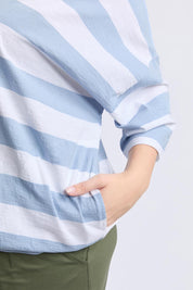 A model wearing the Fundamental Mazie Block Stripe Cotton Sweat in colour Skybluestr (Blue), from the front, cropped image