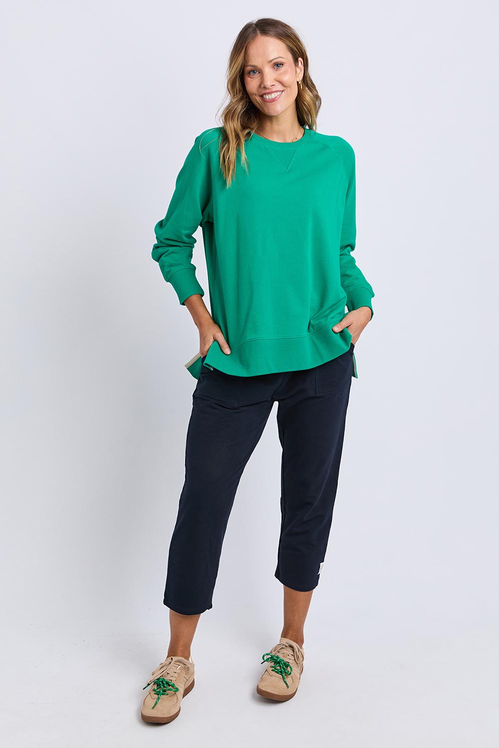 A model wearing the Fundamental Melbourne Crew in colour Turquoise (Green), from the front, showing the whole outfit