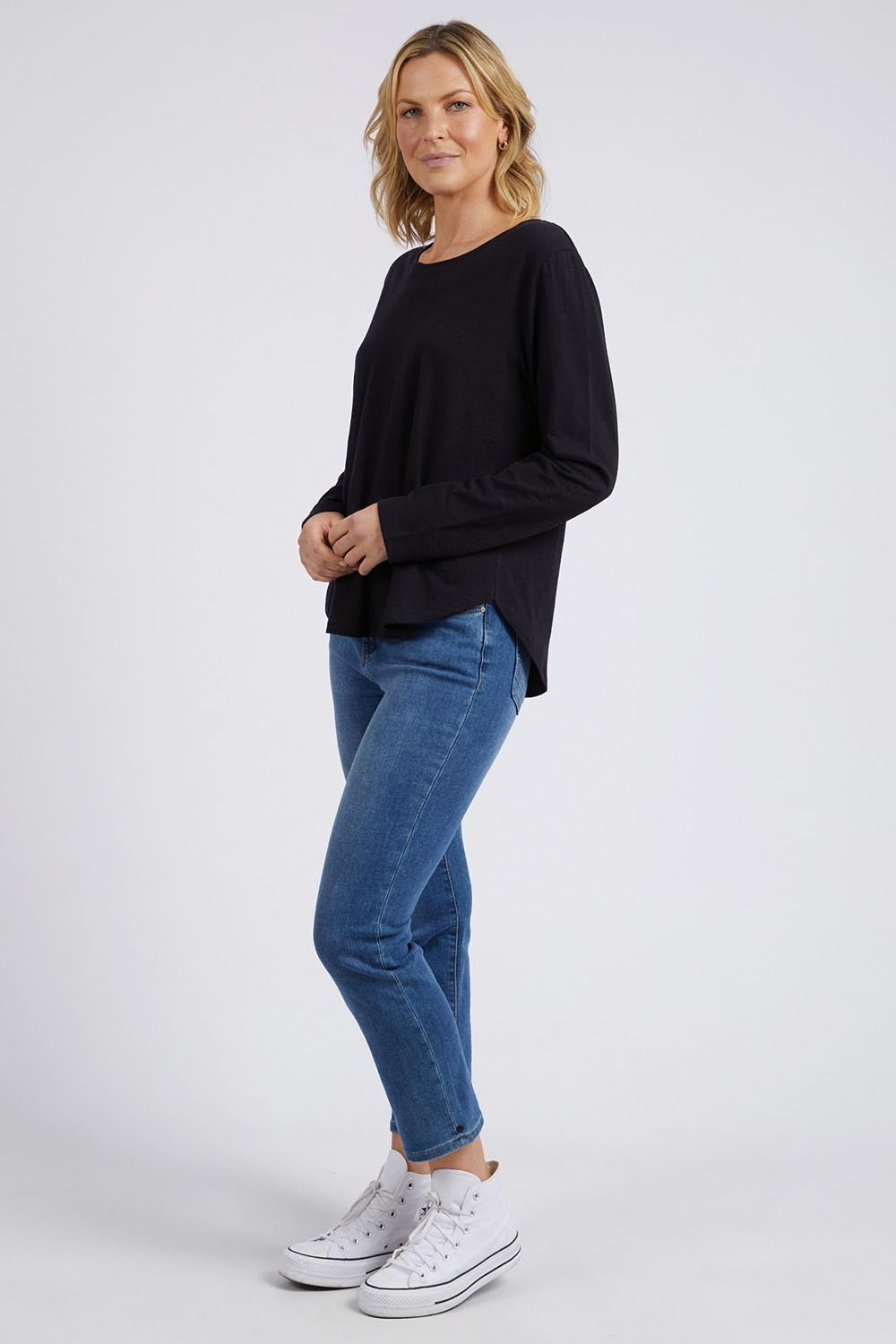 A model wearing the Fundamental Everyday Cotton Long Sleeve Tee in colour Black (Black), from the front, showing the whole outfit