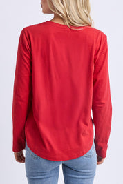 A model wearing the Fundamental Everyday Cotton Long Sleeve Tee in colour Cranberry (Red), from the back