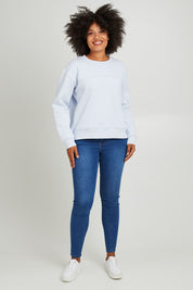 Model Olivia wearing size 10 of the Fundamental Shelly Fleece Crew in colour Lightblue (Blue), from the front, showing the whole outfit