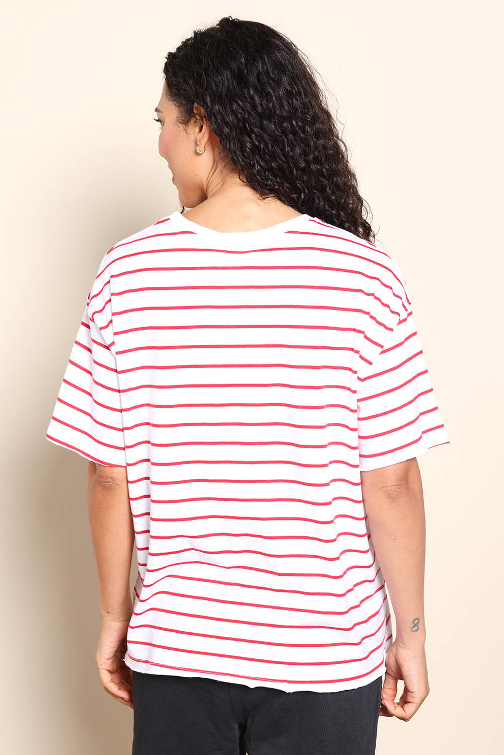 Model Pamelar wearing size 10 of the Fundamental Winona Stripe Cotton Tee - Redwhite in colour Redwhite, from the back