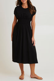 Model Madeline wearing size 10 of the Fundamental Nelle Cotton Midi Dress in colour Black (Black), from the front, cropped image