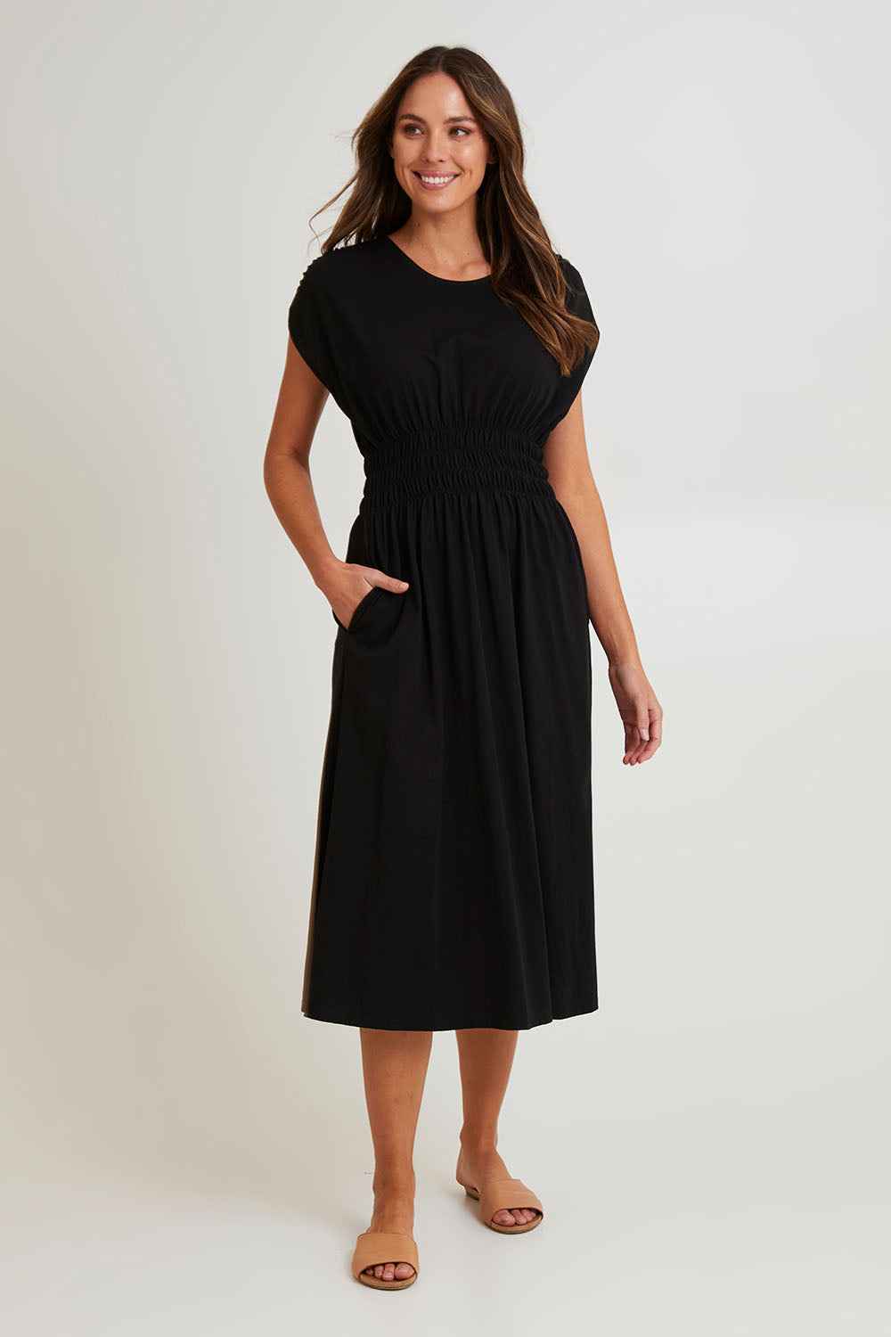 Model Madeline wearing size 10 of the Fundamental Nelle Cotton Midi Dress in colour Black (Black), from the front, showing the whole outfit