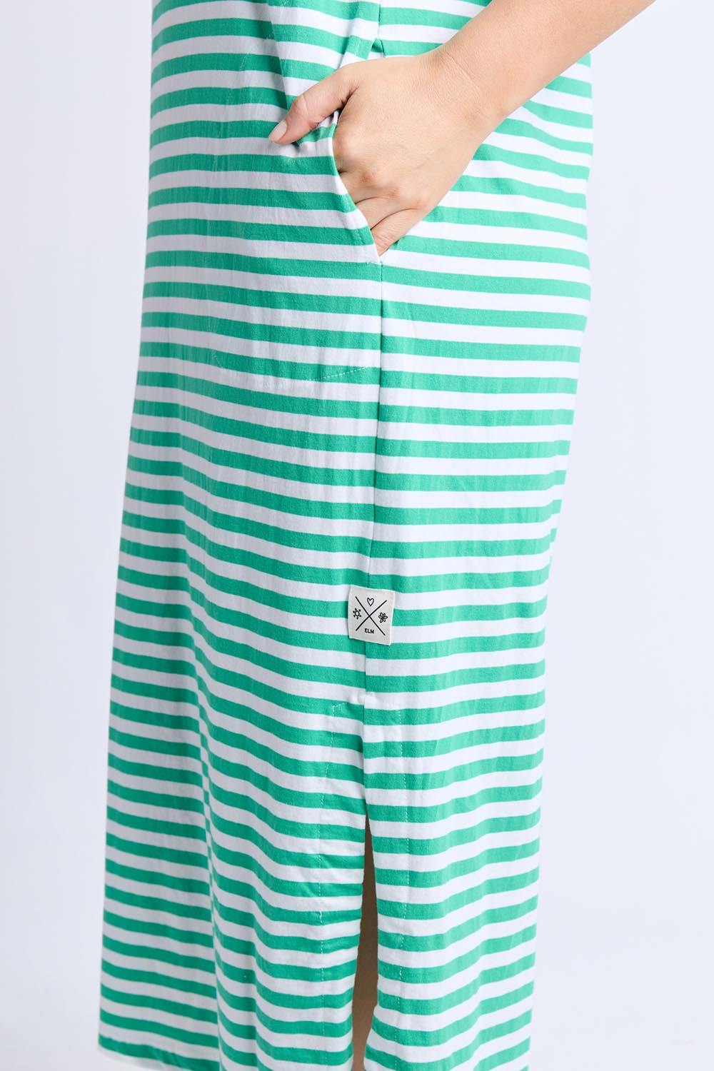 A model wearing the Fundamental Merry Cotton Tee Dress in colour Greenwhite (Blue), from the front, cropped image
