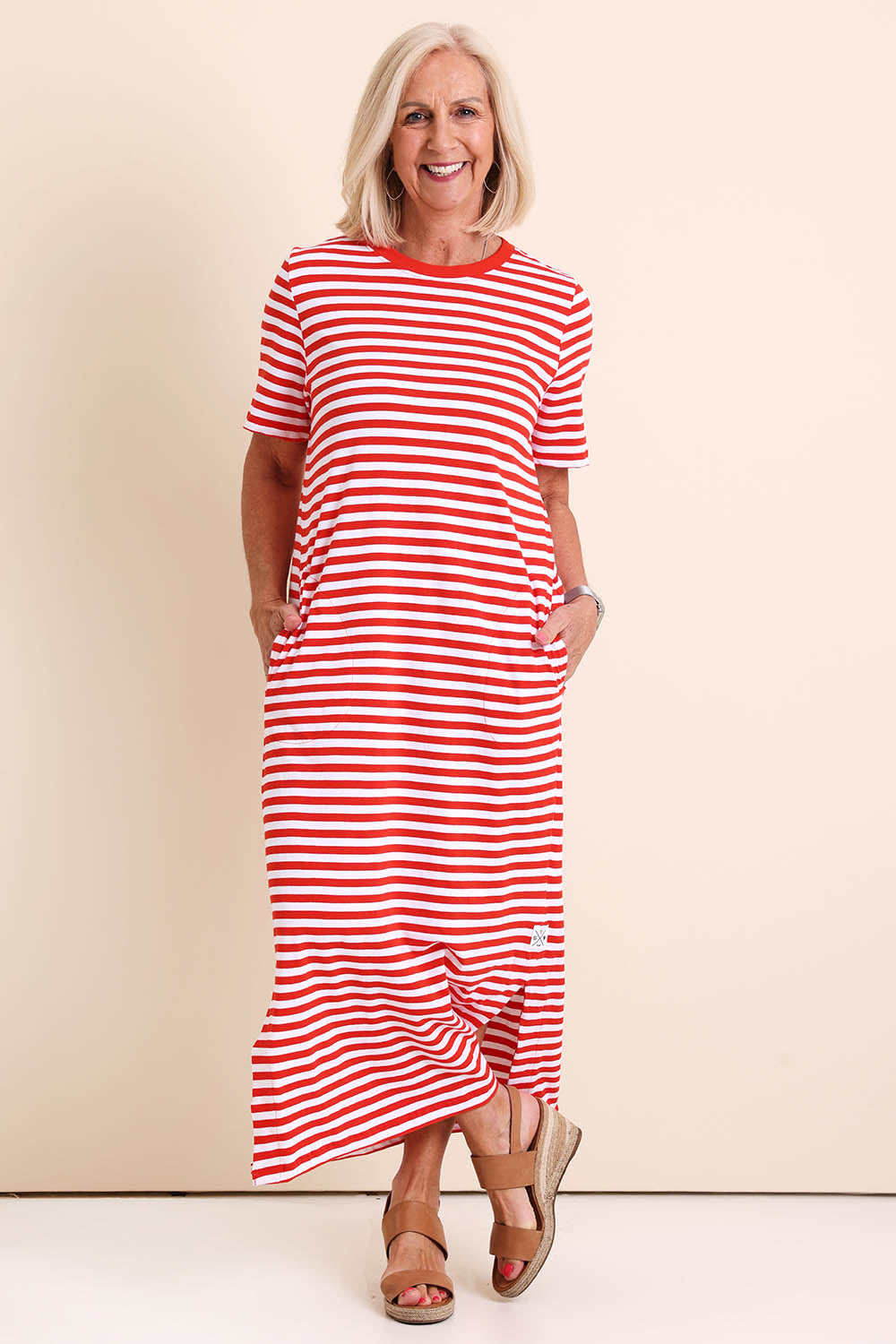 Model Sandys wearing size 10 of the Fundamental Merry Cotton Tee Dress – Tangwht in colour Tangwht, from the front