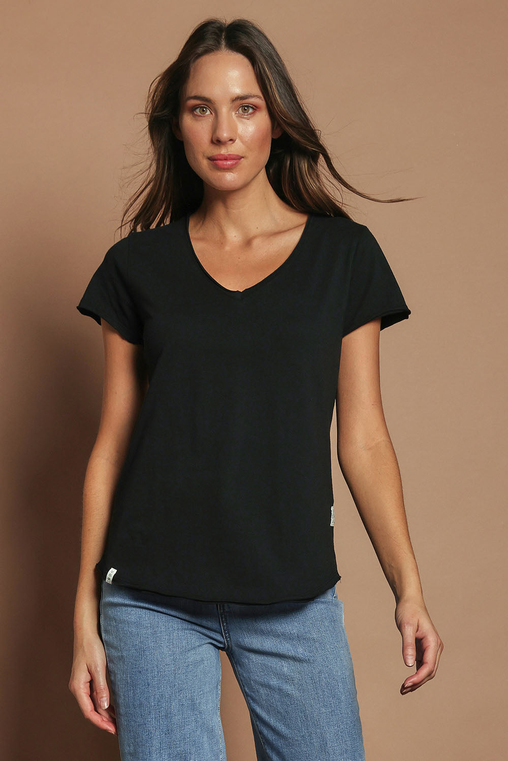 Model Madeline wearing size 10 of the Fundamental Pima Cotton Vee Tee in colour Black (Black), from the front, cropped image