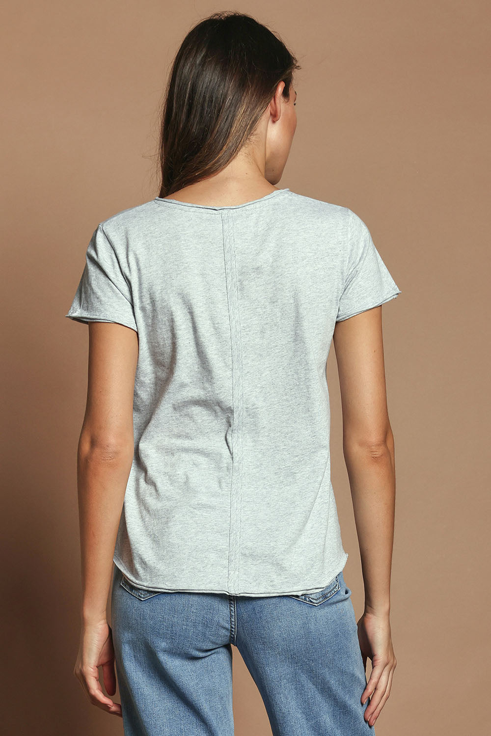 Model Madeline wearing size 10 of the Fundamental Pima Cotton Vee Tee in colour Greymarle (Grey), from the back