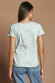 Model Madeline wearing size 10 of the Fundamental Pima Cotton Vee Tee in colour Greymarle (Grey), from the back