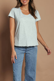 Model Madeline wearing size 10 of the Fundamental Pima Cotton Vee Tee in colour Greymarle (Grey), from the front, cropped image