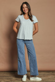 Model Madeline wearing size 10 of the Fundamental Pima Cotton Vee Tee in colour Greymarle (Grey), from the front, showing the whole outfit