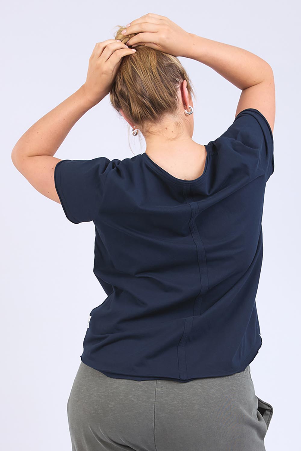 A model wearing the Fundamental Pima Cotton Vee Tee in colour Navy (Blue), from the back