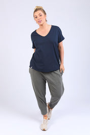 A model wearing the Fundamental Pima Cotton Vee Tee in colour Navy (Blue), from the front, showing the whole outfit