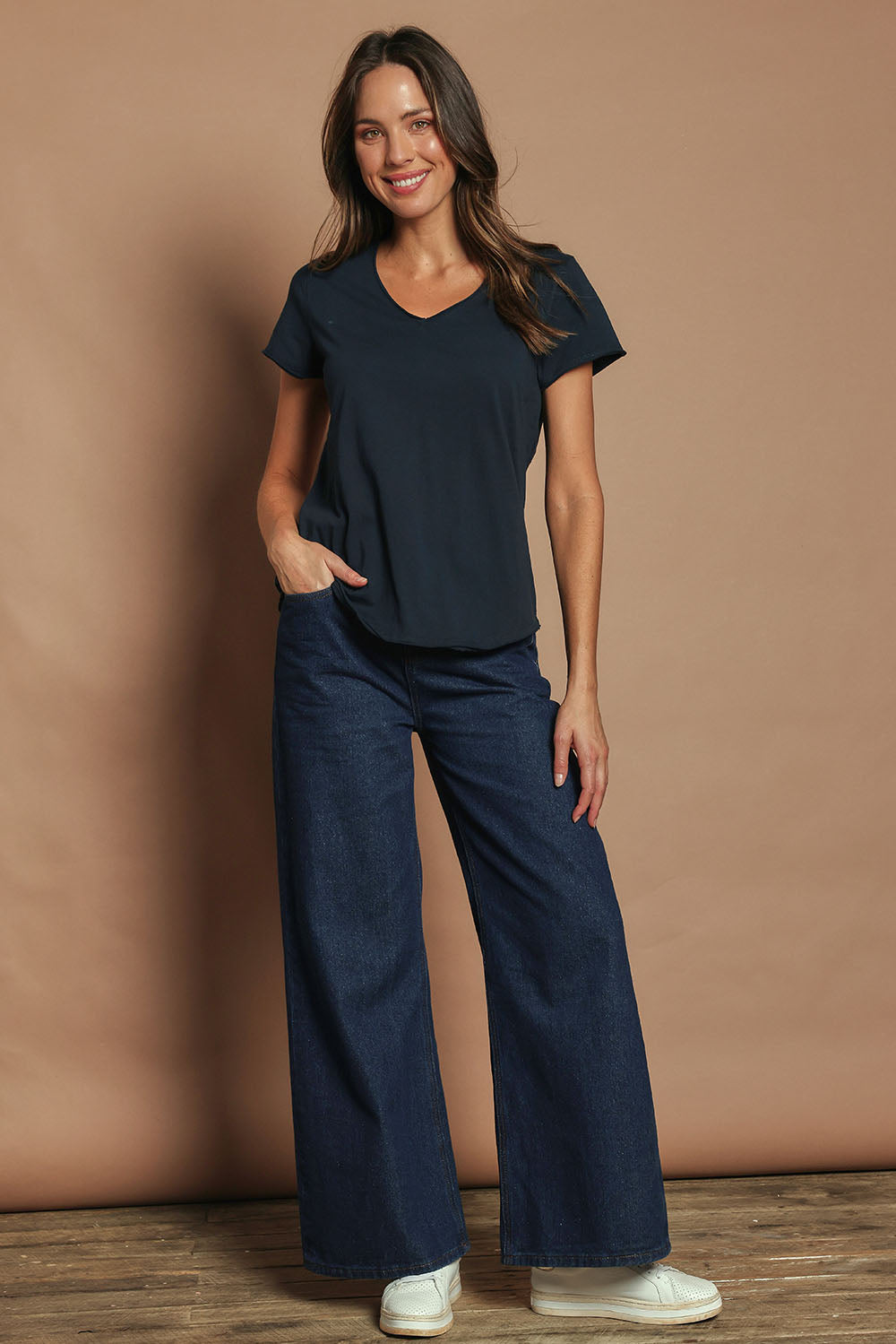 Model Madeline wearing size 10 of the Fundamental Pima Cotton Vee Tee in colour Navy (Blue), from the front, showing the whole outfit
