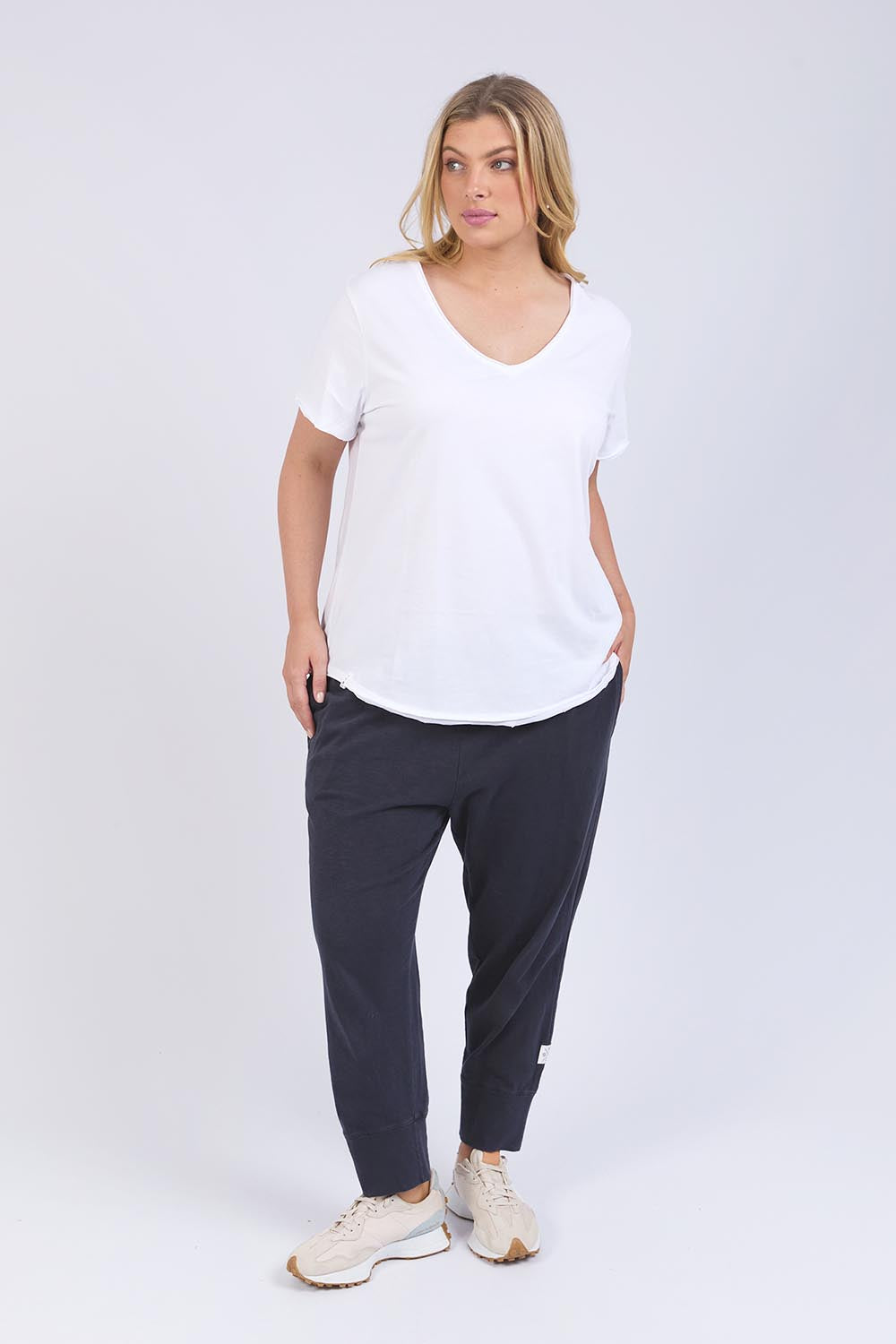 A model wearing the Fundamental Pima Cotton Vee Tee in colour White (White), from the front, showing the whole outfit