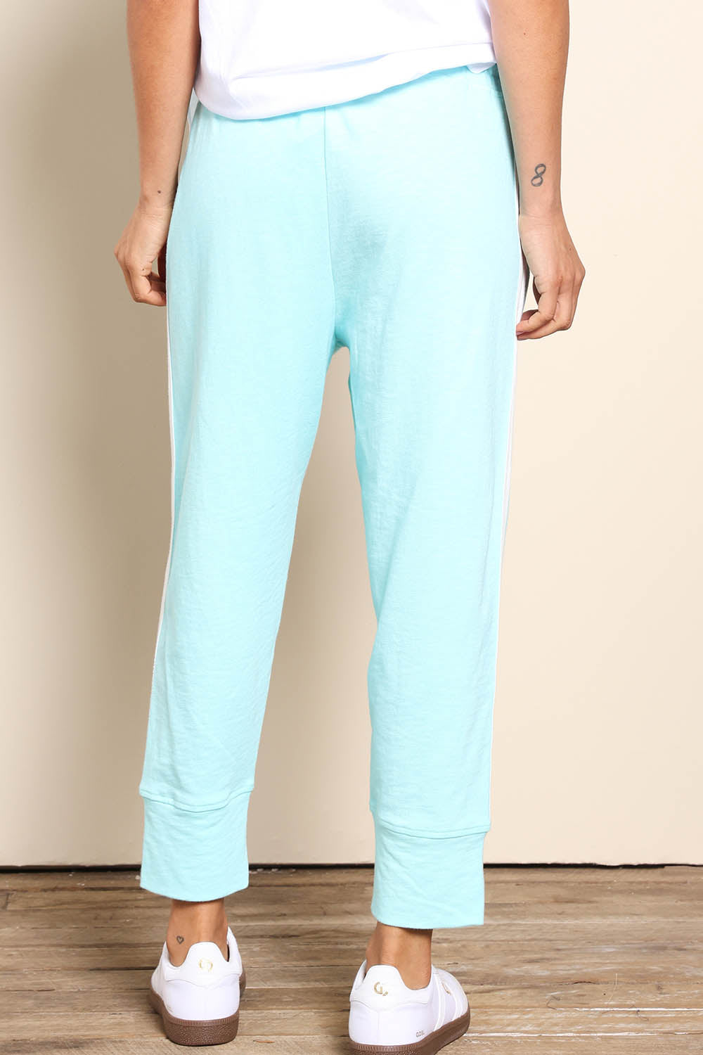Model Pamelar wearing size 10 of the Fundamental Brunch Cotton Side Tape Pant – Tonicblue in colour Tonicblue, from the front