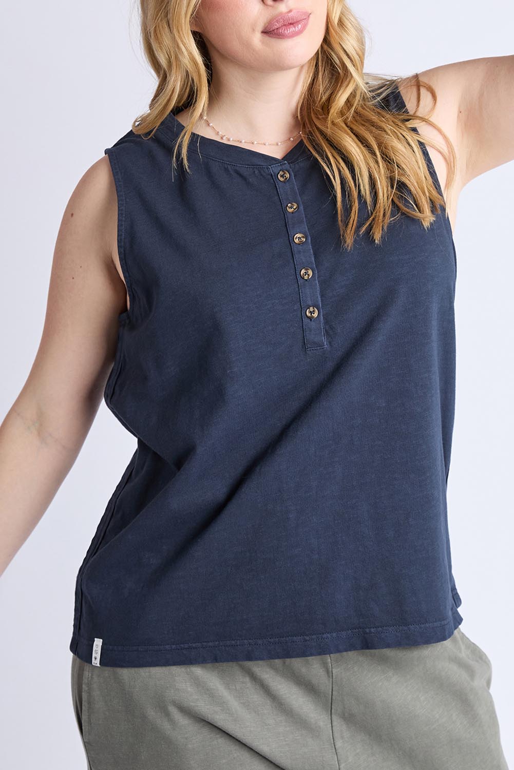 A model wearing the Fundamental Elysian Cotton Tank in colour Navy (Blue), from the front, cropped image