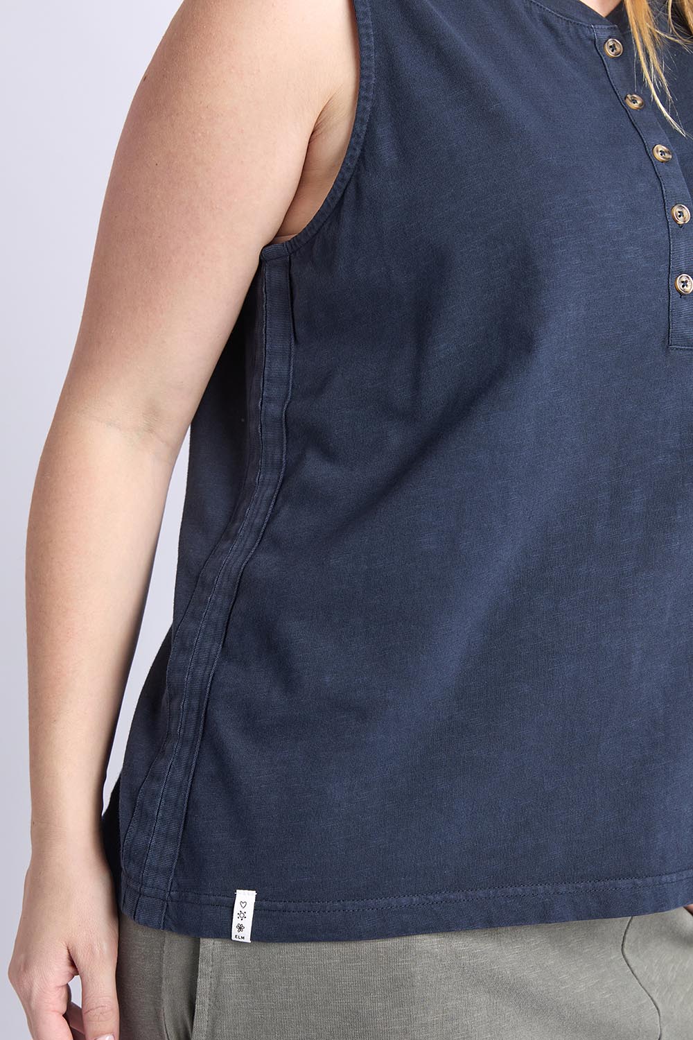 A model wearing the Fundamental Elysian Cotton Tank in colour Navy (Blue), from the front, cropped image