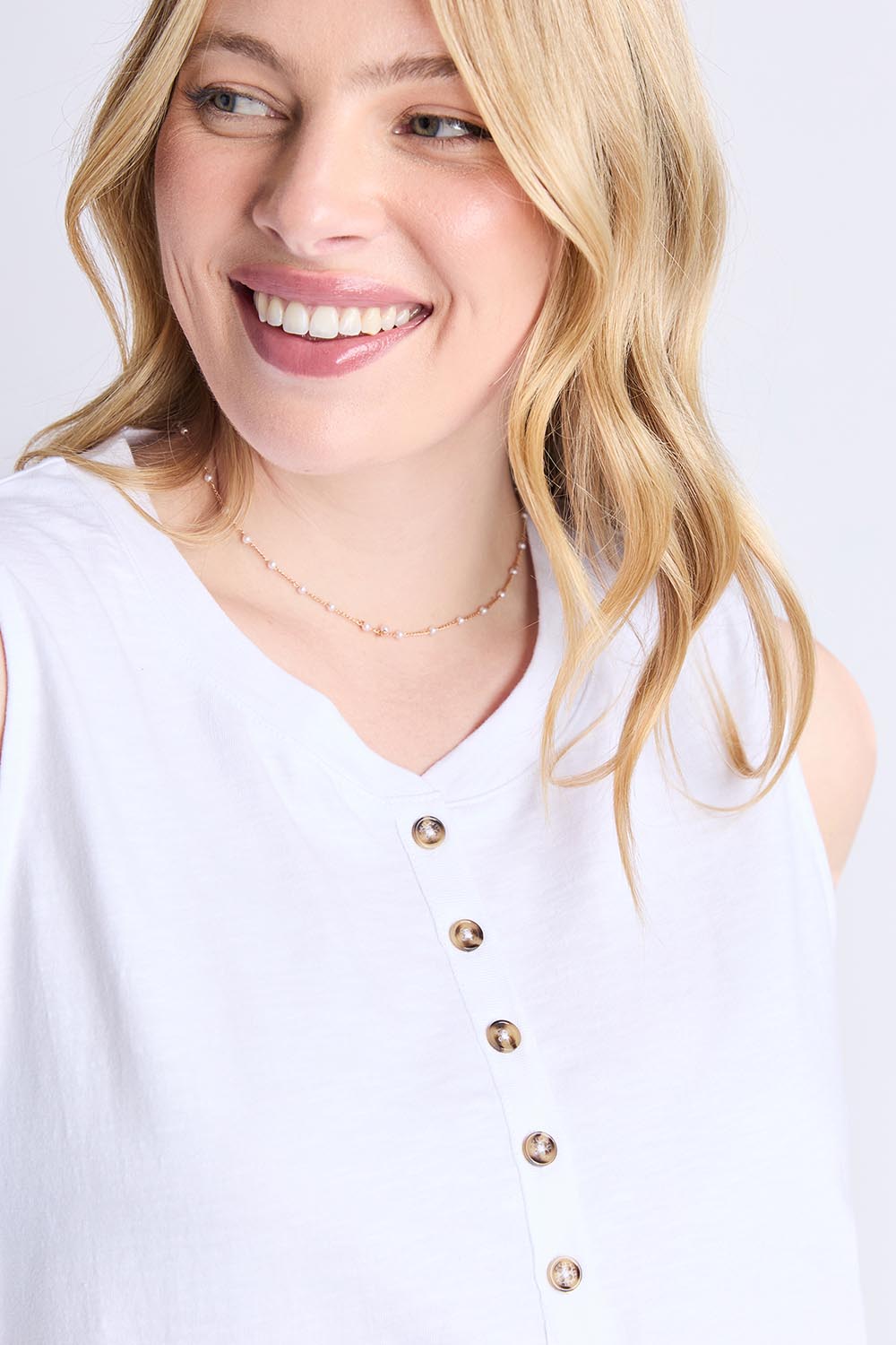 A model wearing the Fundamental Elysian Cotton Tank in colour White (White), from the front, cropped image