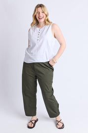 A model wearing the Fundamental Elysian Cotton Tank in colour White (White), from the front, showing the whole outfit