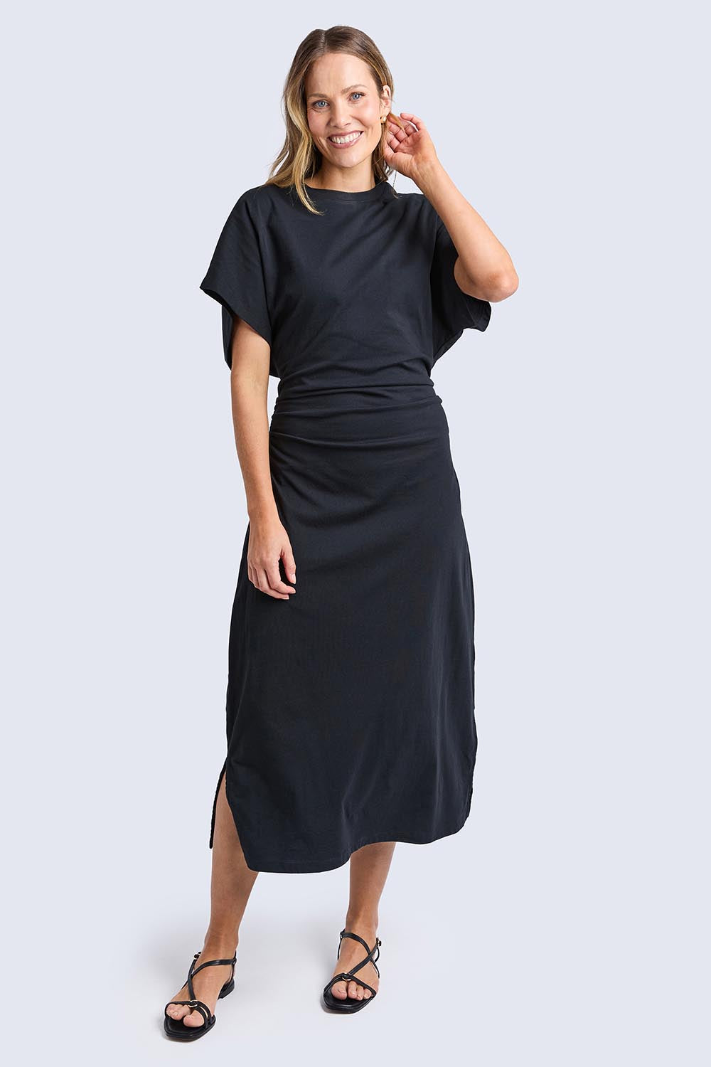 A model wearing the Fundamental Colette Cotton Dress in colour Black (Black), from the front, showing the whole outfit