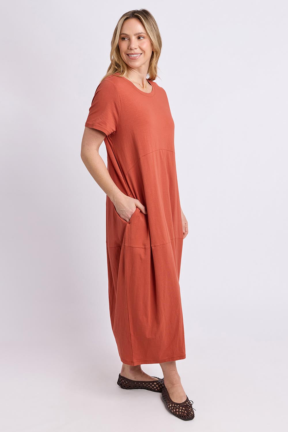 Model Genericm wearing size sample of the Fundamental Diana Cotton Tee Dress - Earth in colour Earth, from the front