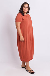 Model Genericm wearing size sample of the Fundamental Diana Cotton Tee Dress - Earth in colour Earth, from the front