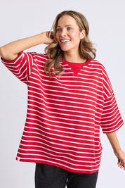 A model wearing the Fundamental Valentina Sweat in colour Cranbwhit (Red), from the front, cropped image