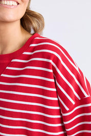 A model wearing the Fundamental Valentina Sweat in colour Cranbwhit (Red), from the front, cropped image