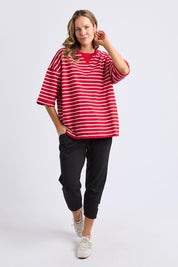 A model wearing the Fundamental Valentina Sweat in colour Cranbwhit (Red), from the front, showing the whole outfit