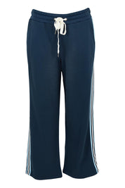 Product shot of the Fundamental Amara Trackpant in colour Navystripe (Blue), from the front
