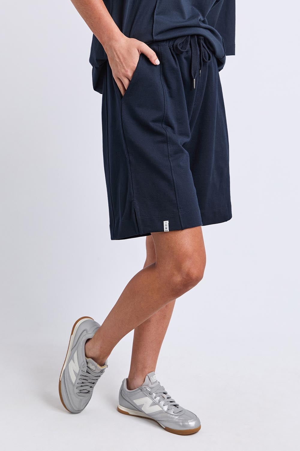 Model Genericm wearing size sample of the Fundamental Summer Fleece Cotton Short – Navy in colour Navy, from an angle