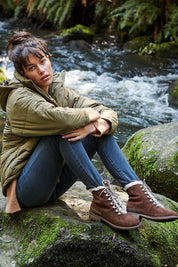 A model wearing the Billington Waterproof Boot in colour Oak, from the front, showing the whole outfit