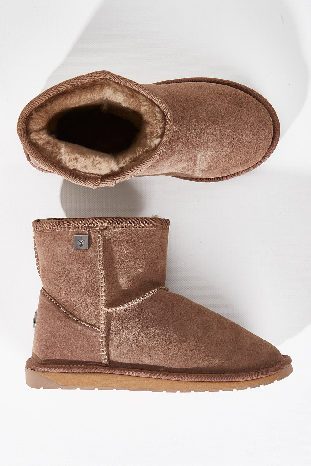 A model wearing size 7 of the Platinum Stinger Mini Ugg Boots in colour Mushroom, from the front, showing the whole outfit