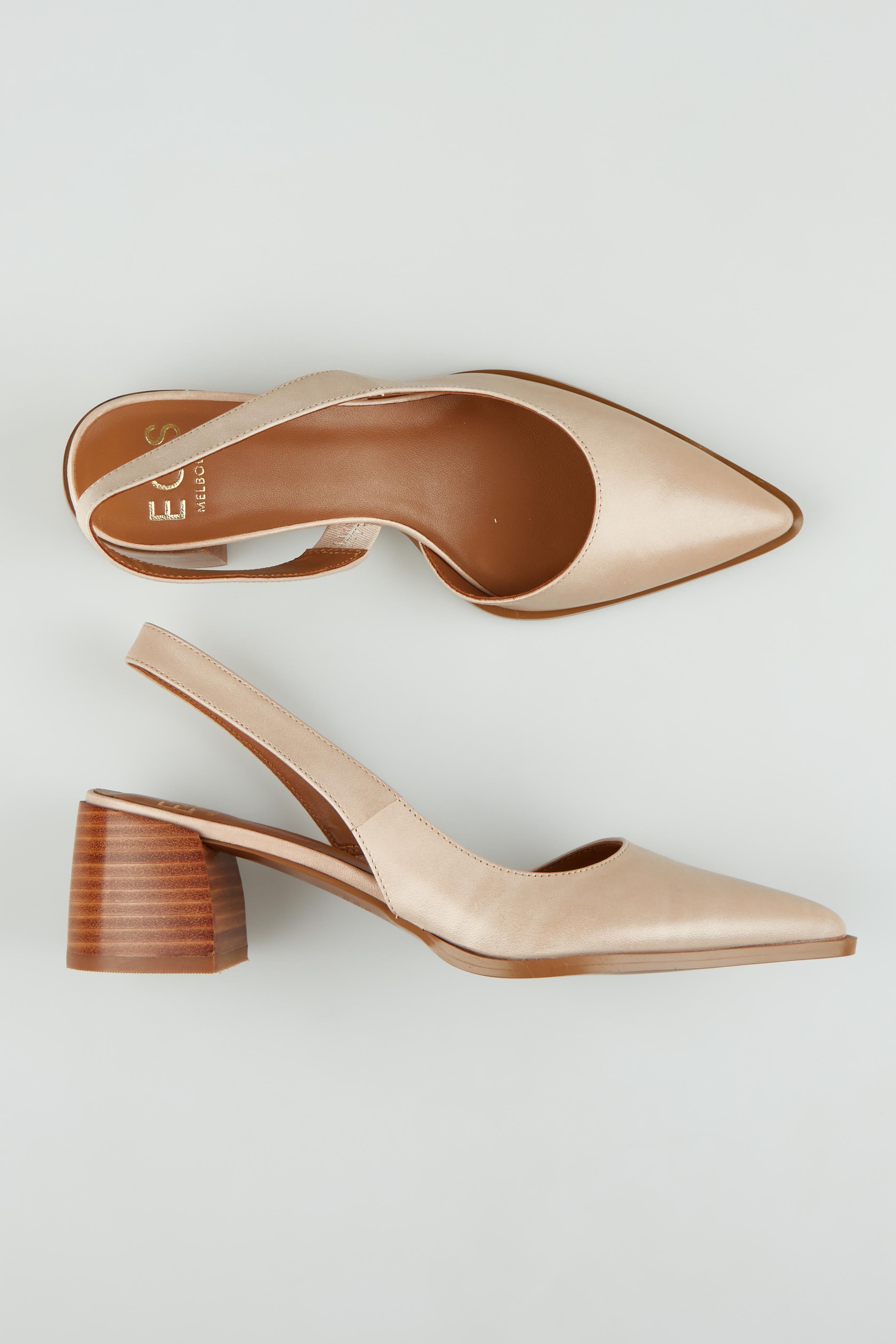 A model wearing size 37 of the Aura Leather Heel in colour Nude, from the front, showing the whole outfit