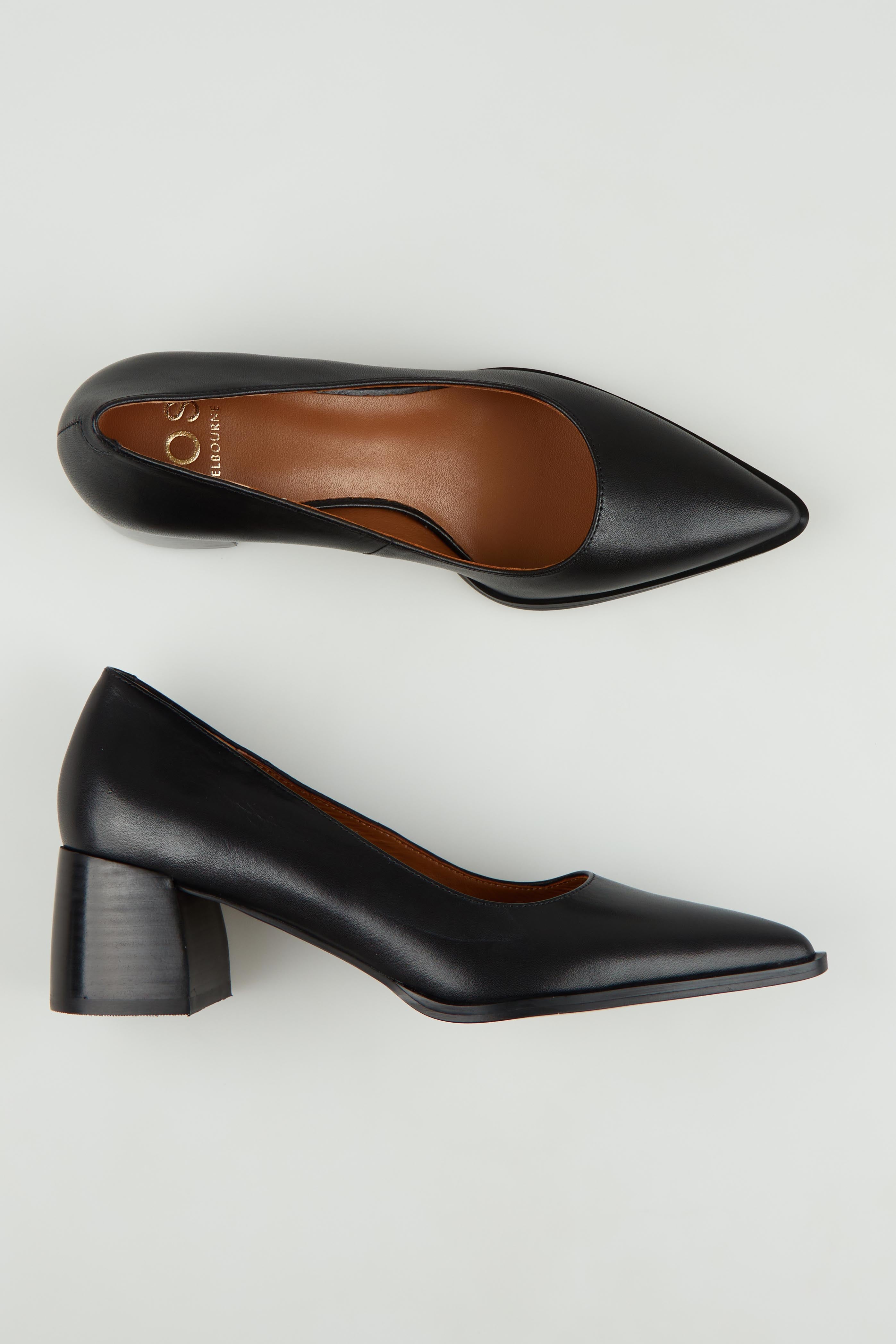 A model wearing size 37 of the Auris Leather Heel in colour Black (Black), from the front, showing the whole outfit